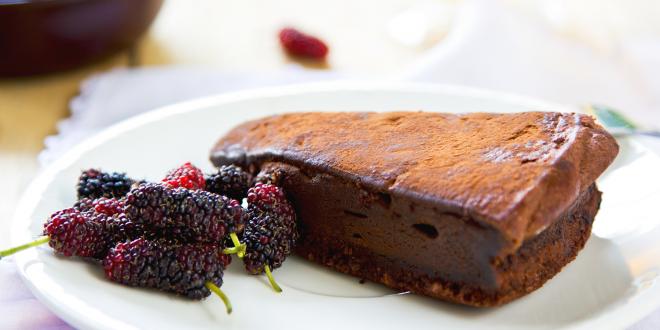 Chocolate truffle torte by berries and tea.