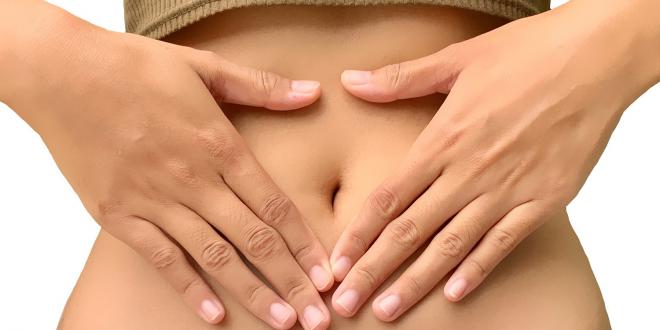 a woman massaging her abdomen