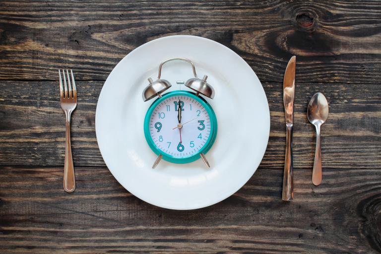 a clock on a dinner plate