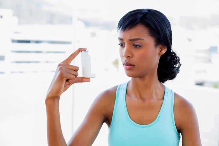 A woman wondering about her asthma inhaler