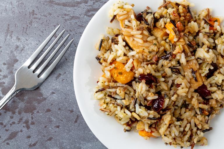 a plate of wild rice stuffing with fruit